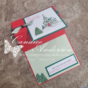 A reverse easel Christmas card featuring a snow-covered church and trees, with a red and green color scheme and festive greeting.