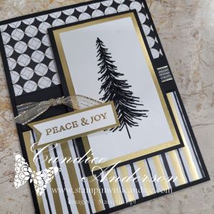 A handmade Christmas card featuring a black and white geometric design, accentuated with gold trim. The focal point is a stamped black silhouette of a pine tree, accompanied by a gold and white 'PEACE & JOY' greeting.