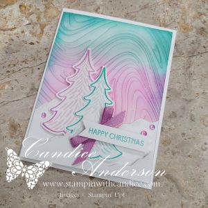 A whimsical holiday card featuring two pastel decorative trees against a swirled purple and teal background, embellished with 'Happy Christmas' sentiment and decorative dots.