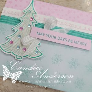 A pastel Christmas card featuring a decorated tree with gemstone accents and a sentiment that reads 'MAY YOUR DAYS BE MERRY' on a softly blended background.