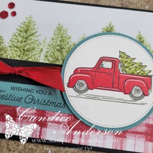 A festive card featuring a little red truck carrying a Christmas tree, surrounded by green pine trees and a celebratory message.