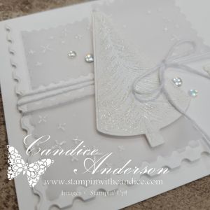 An all-white handmade card featuring a textured tree design, embellished with sparkle and pearls, capturing a serene, winter-themed aesthetic.