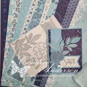 A collection of patterned papers in shades of blue and purple, with a completed card featuring layered leaves and a sentiment that reads 'Tis the Season'.