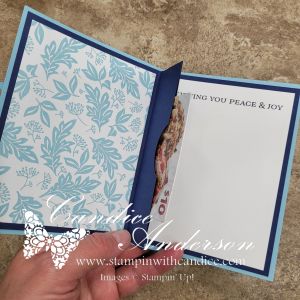 An open pop-up gift card holder card, featuring a floral patterned interior with a space for a gift card, and a printed message that reads 'WISHING YOU PEACE & JOY'.
