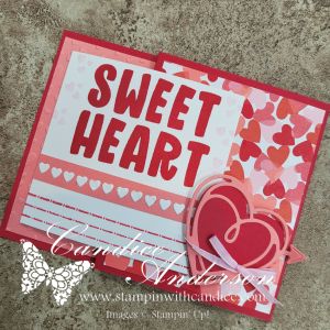 A handmade greeting card featuring the words 'SWEET HEART' in bold red letters, adorned with heart patterns in pink and red colors, and a layered heart embellishment on the side.