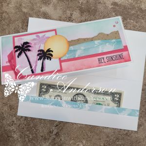 A colorful greeting card design featuring palm trees and a sun, with the text 'HEY, SUNSHINE'. The card is partially open, revealing a two-dollar bill inside.