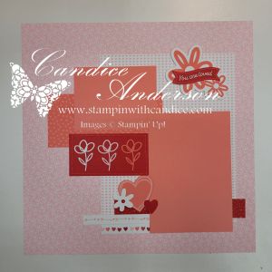A scrapbook layout featuring a pink background with patterned layers, floral illustrations, and decorative elements, including the text 'You are loved' and various shapes such as hearts and flowers.