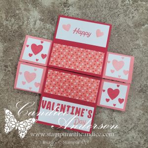 A handmade Valentine's Day card featuring a pop-up design with the text 'Happy Valentine's Day' and decorative elements including hearts in shades of pink and red.