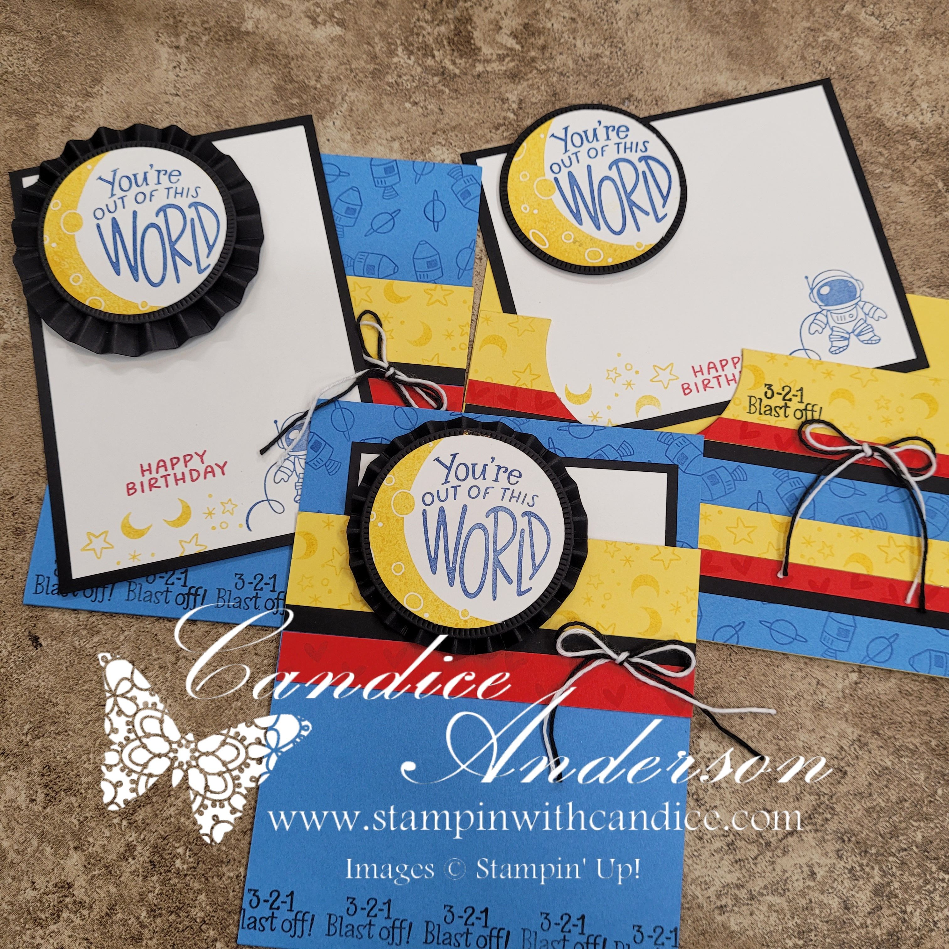 Three handmade birthday cards featuring a space theme. Each card has a yellow and blue color scheme with text that says 'You're Out of This World.' One card includes an astronaut illustration, while another features the phrase '3-2-1 Blast off!' Various design elements like stars and moons are incorporated.